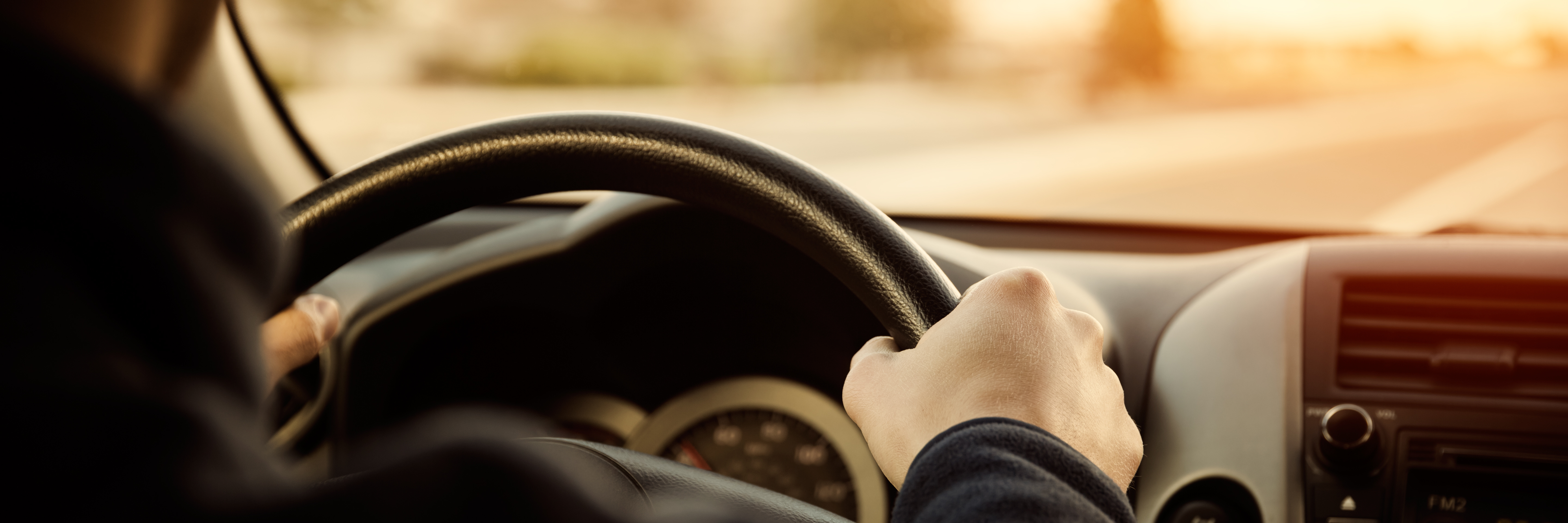 Driving-car-hands-on-steering-wheel
